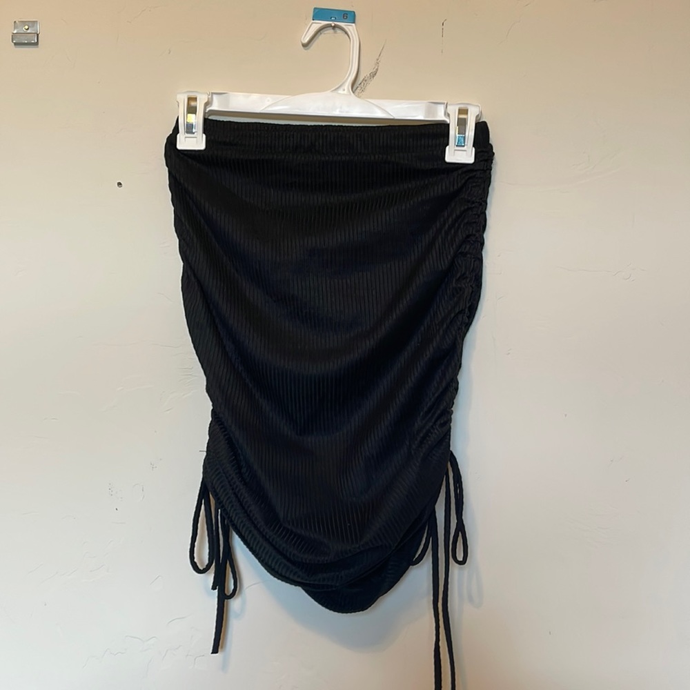 black mini skirt with ties on the side to sinch and adjust length